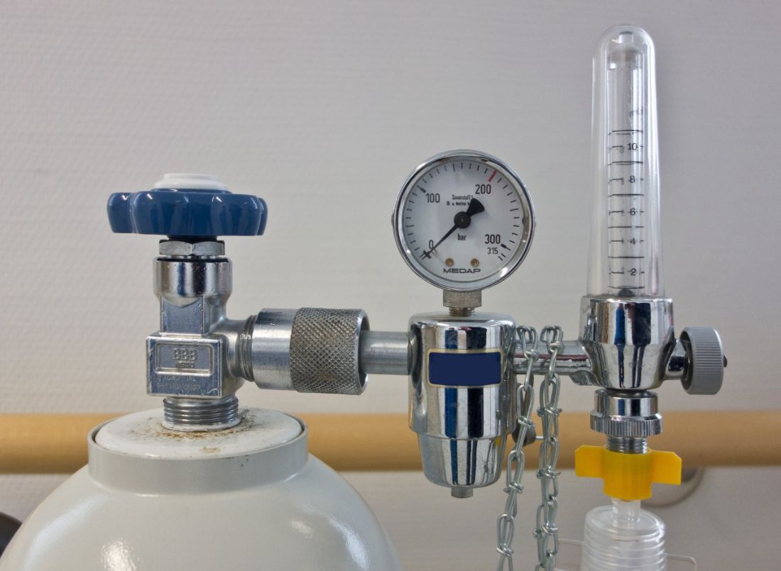 An oxygen cylinder regulator with a pressure gauge and a flowmeter